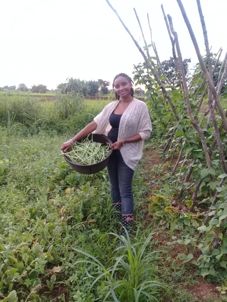 AGF founder Hanaan smiles as she holds a large basket of vegetables